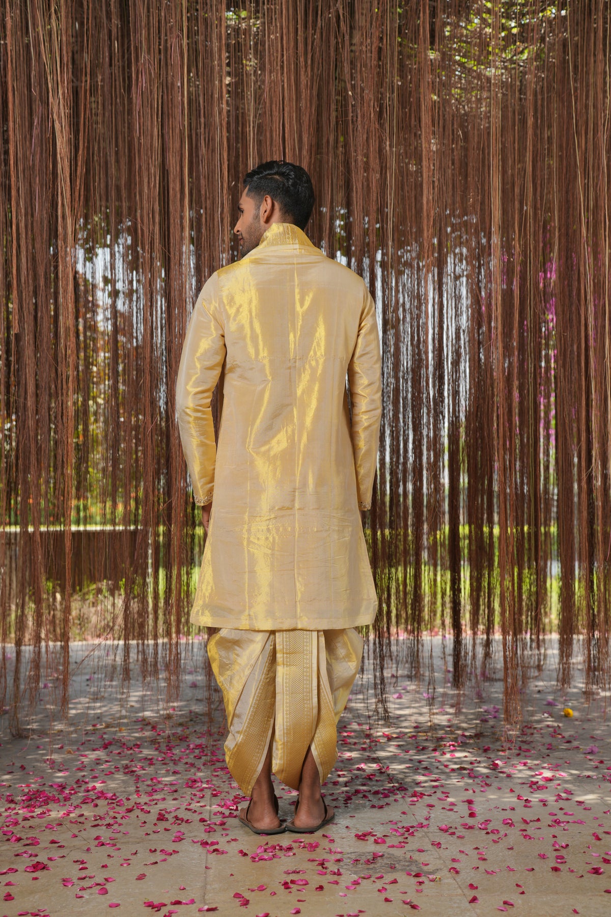 Back view of a gold pattu kurta set